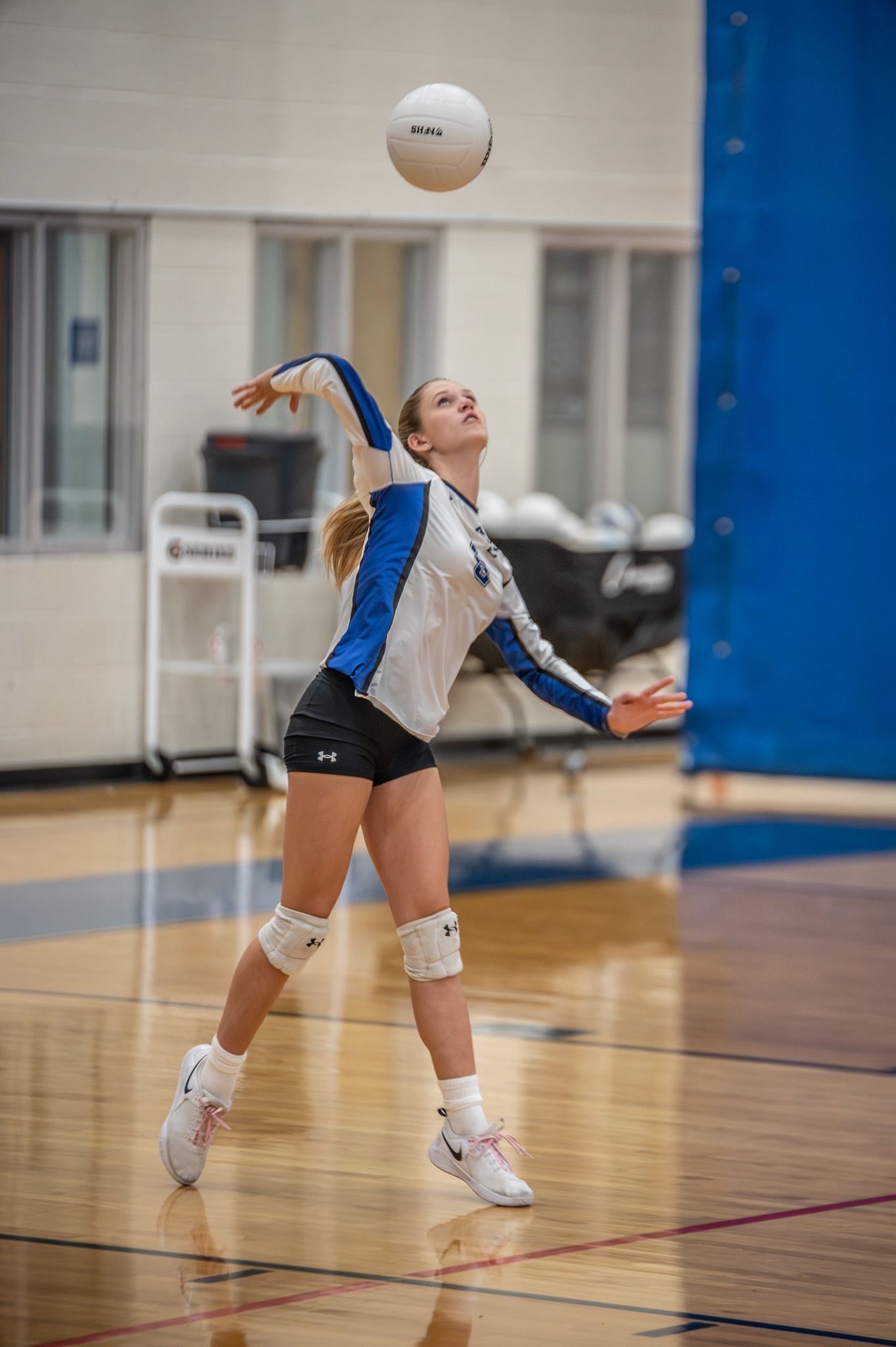 Volleyball player serving the ball during a match